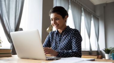 Woman working remotely from her desktop computer