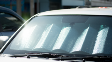 Front view of parked car with a sun shield on the windshield