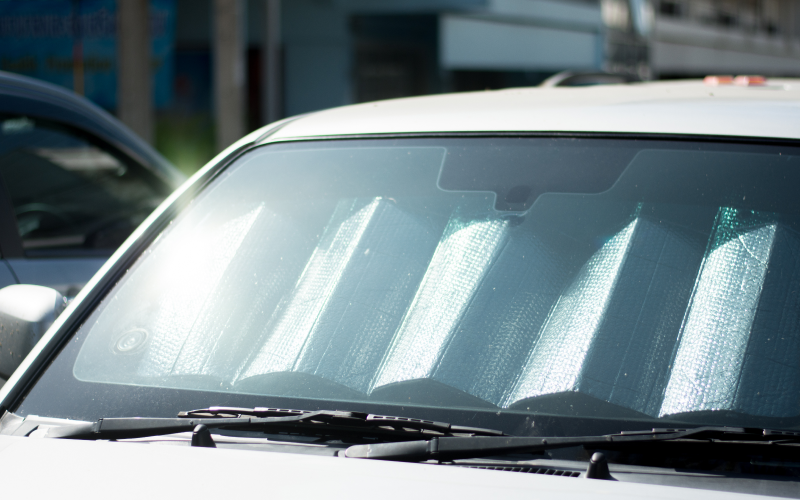 Front view of parked car with a sun shield on the windshield