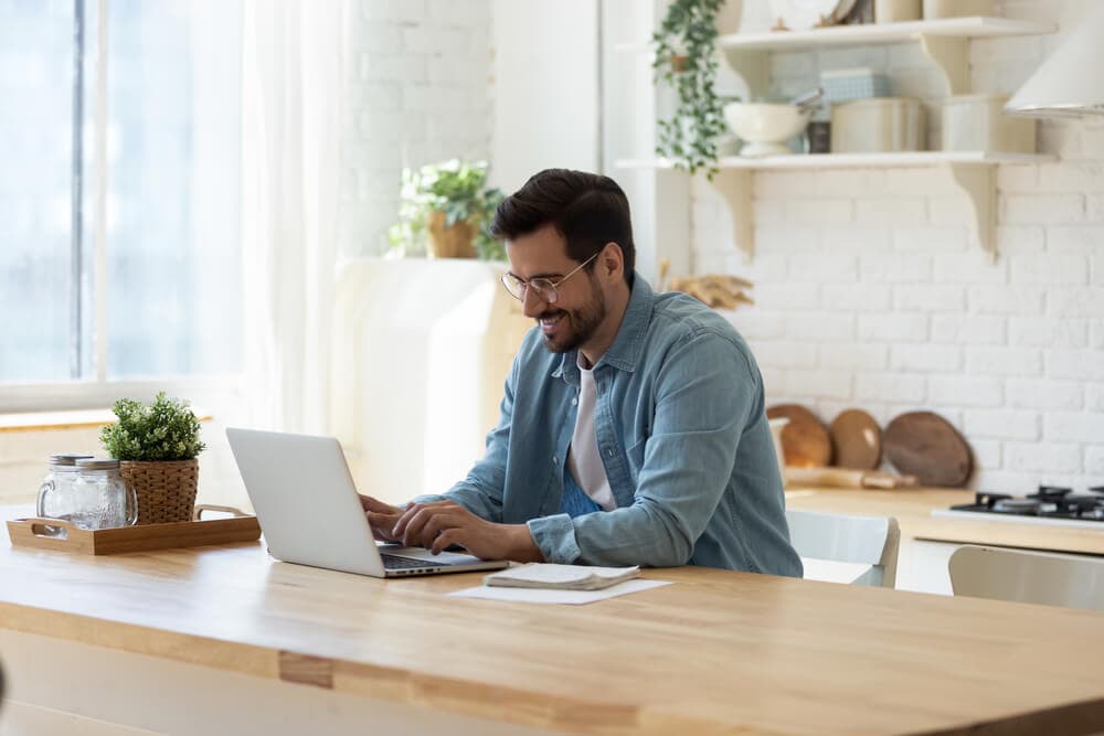 happy young car insurance agent with laptop offering online services