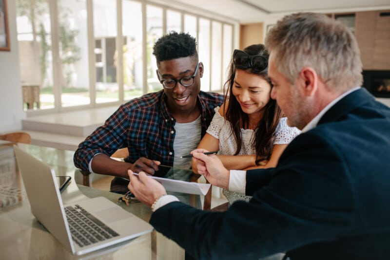 An insurance agent works with a biracial couple