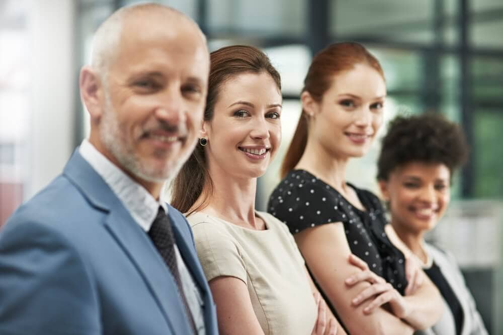 Group of smiling, diverse people waiting for an interview as an insurance agent.