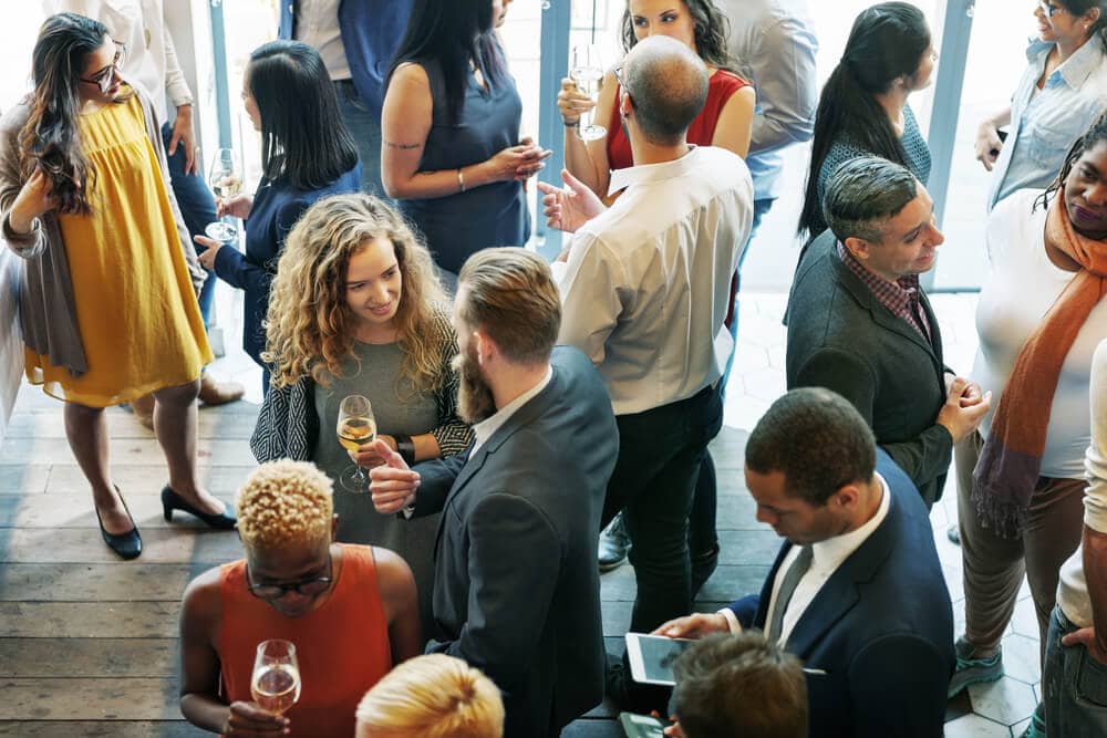 People attending an insurance agent conference milling about in between sessions.