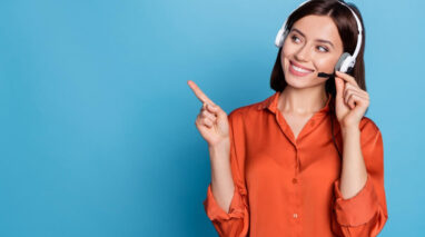 Smiling female agent pointing with finger