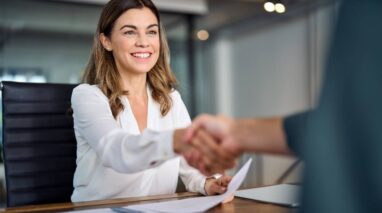 Woman shaking hands with customet - Bluefire