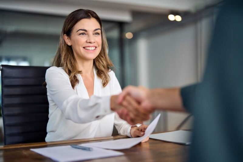 Woman shaking hands with customet - Bluefire