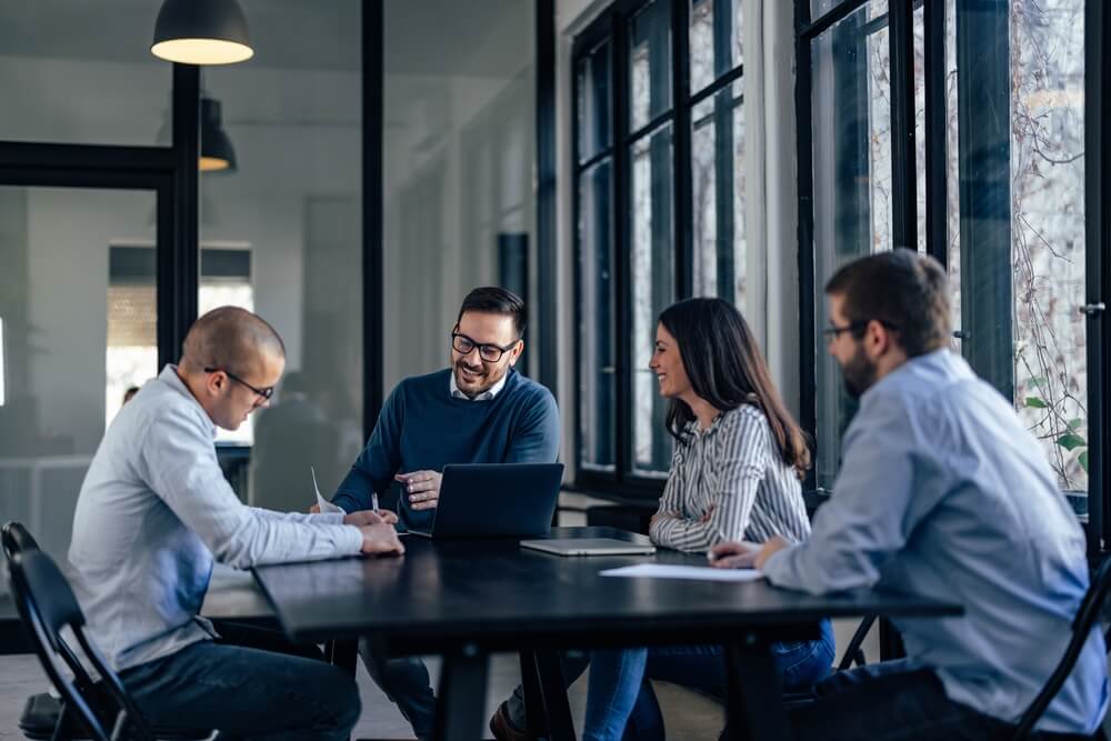 Group of work peers gather for a meeting.