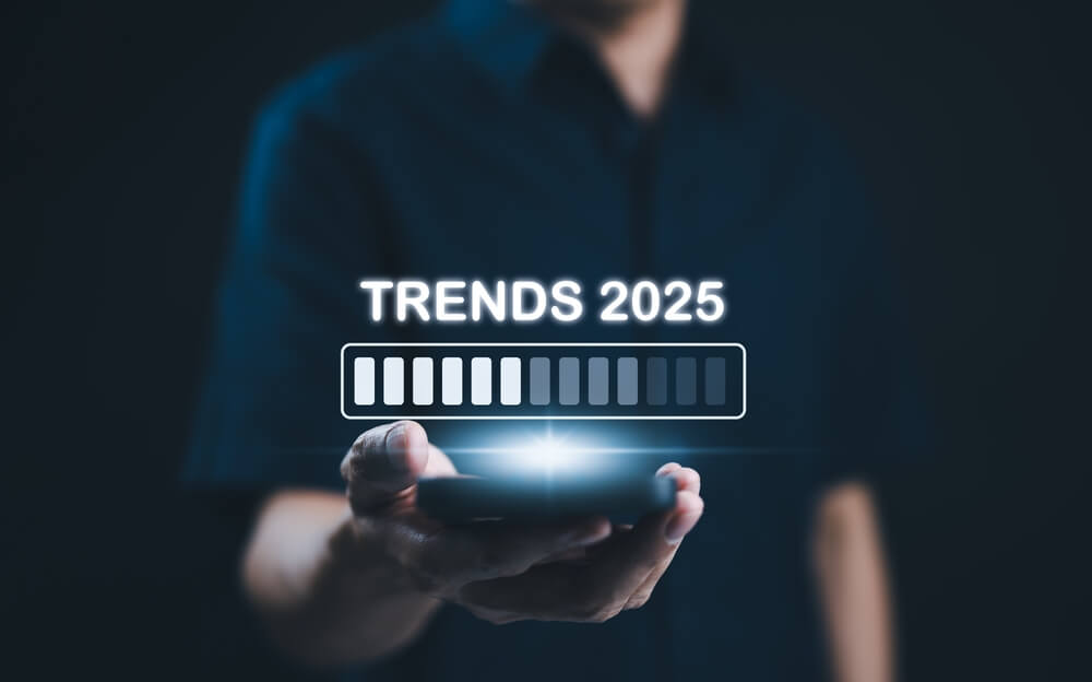 A hand holding an illustration depicting trends 2025.