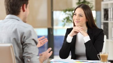 An independent insurance agent listens intently as her customer talks.