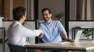 Two business partners shake hands - partner with Bluefire Insurance.