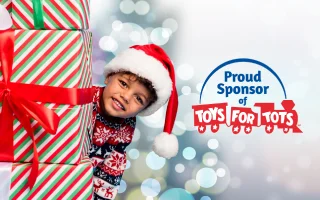 Child smiling with a gift, next to 'Proud Sponsor of Toys for Tots' logo.